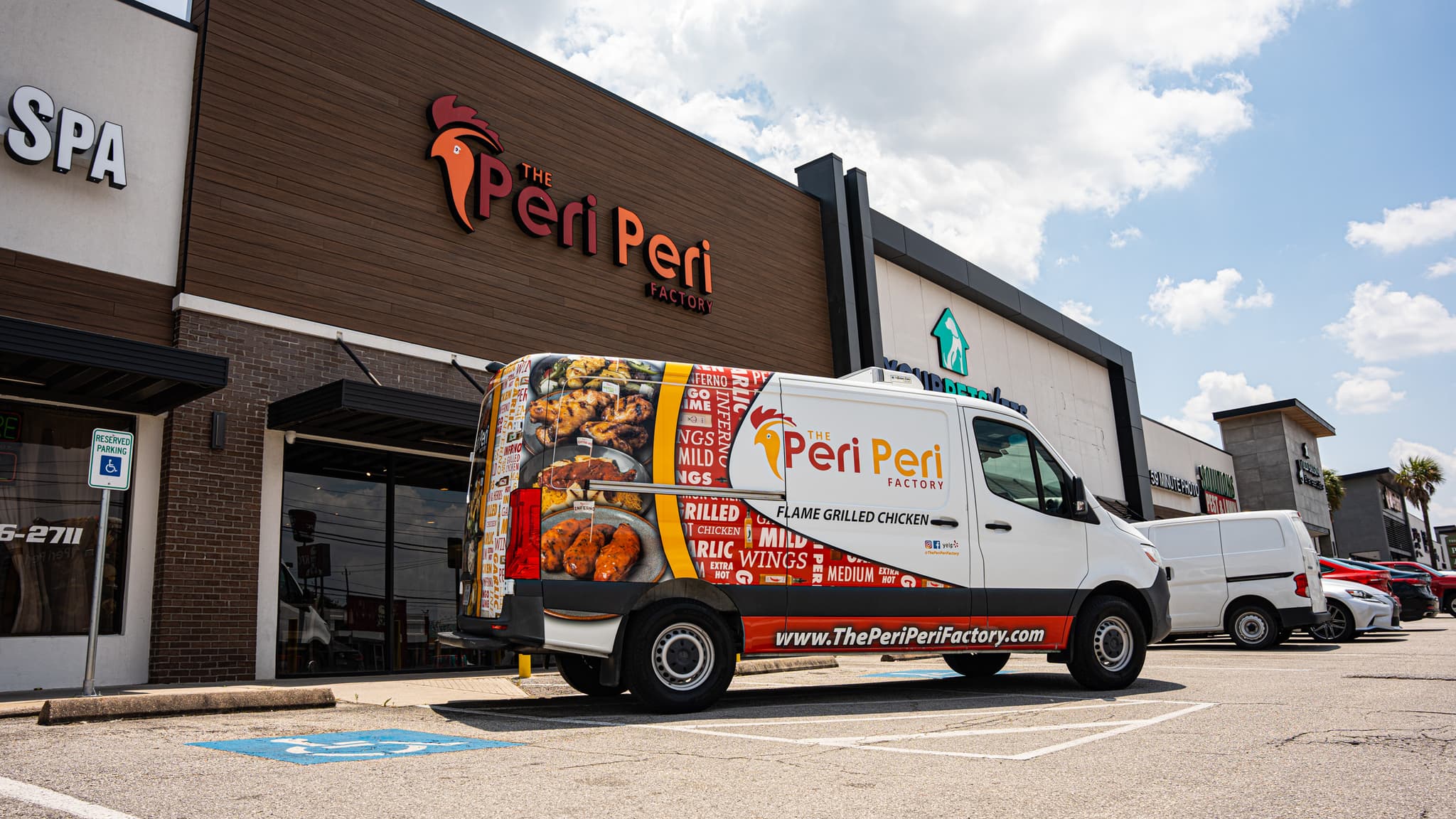 A Peri Peri factory truck parked in front of the restaurant building