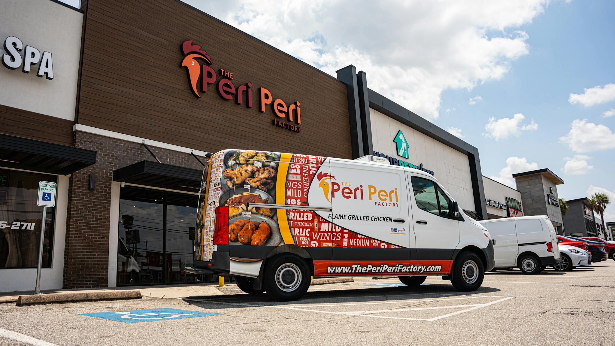 A Peri Peri factory truck parked in front of the restaurant building